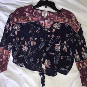 button up blouse with tie in the front.